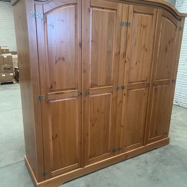 e1c8bd1f-6694-48f4-a7e2-822a5a3c405d Ropero mexicano rústico de madera color caramelo con puertas de panel y herrajes metálicos negros, ideal para almacenamiento y decoración clásica